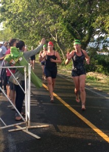 I'm reaching up for a high five to my sister and telling her that the swim was super choppy. I'd also like to point out that the the women in the green caps were in the wave in front of me. Boom!