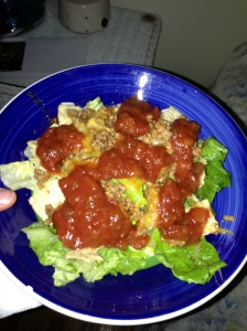 Dinner: Taco salad - ground beef, shredded Mexican cheese, crumbled tortilla chips and salsa all over romaine lettuce. I took this picture in the dark of my bedroom where my phone was. Your welcome.